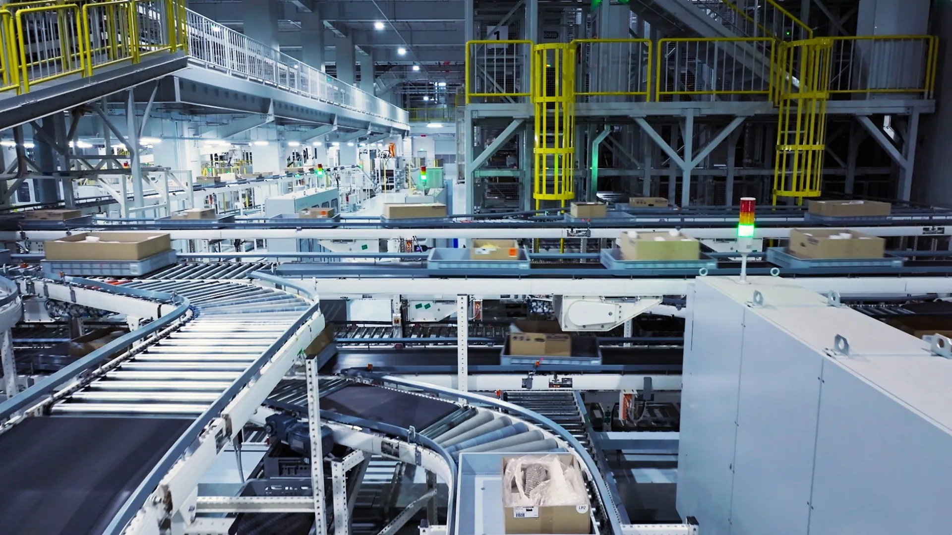 Industrial manufacturing facility interior with conveyor belt systems and mezzanine walkways